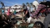 Typhoon survivors and volunteers begin a massive clean up in typhoon-ravaged Tacloban city, Leyte province in central Philippines, Nov. 25, 2013. 