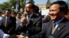 Opposition leader of Cambodia National Rescue Party Sam Rainsy, center, delivers a speech next to his Deputy President Kem Sokha, right, during a gathering to mark Human Rights Day, in front of National Assembly, in Phnom Penh, Cambodia, file photo. 