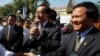 Opposition leader of Cambodia National Rescue Party Sam Rainsy, center, delivers a speech next to his Deputy President Kem Sokha, right, during a gathering to mark Human Rights Day, in front of National Assembly, in Phnom Penh, file photo. 
