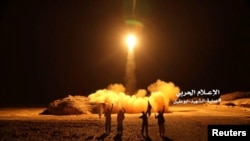FILE - A photo distributed by the Houthi Military Media Unit shows the launch by Houthi forces of a ballistic missile aimed at Saudi Arabia March 25, 2018. 