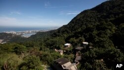 Houses in the Enchanted Valley sustainable community stand on the outskirts of Tijuca National Forest in Rio de Janeiro, Brazil, June 6, 2022.