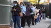 People queue for a COVID-19 test in Melbourne on May 27, 2021 after five million people in Melbourne were ordered into a snap week-long lockdown following another COVID-19 virus outbreak. 