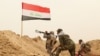 Fighters from the Badr Brigades Shiite militia clash with Islamic State militant group at the front line, on the outskirts of Fallujah, Anbar province, Iraq, Monday, June 1, 2015. 