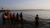 Vietnamese fishermen collect catches from the Mekong river near Arey Ksat village on the outskirts of Phnom Penh, Cambodia, Feb. 6, 2014.