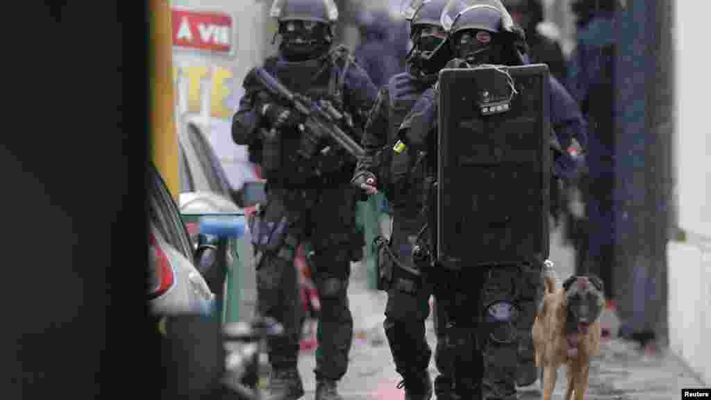 La police d'intervention del'armée française patrouille avec un chien renifleur sur les lieux d'une fusillade dans la rue de Montrouge, près de Paris, le 8 janvier 2015.
