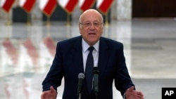 Lebanese Prime Minister-designate Najib Mikati, speaks to journalists after his meeting with Lebanese President Michel Aoun, at the Presidential Palace in Baabda, east of Beirut, Lebanon, July 26, 2021.