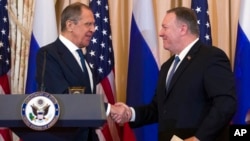 Secretary of State Mike Pompeo, right, shake hands with Russian Foreign Minister Sergey Lavrov, after a media availability at the State Department in Washington, Dec. 10, 2019.