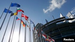 FILE - Flags of European Union member states fly in front of the European Parliament building in Strasbourg, France, April 15, 2014.