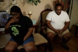 Cousins Latasha Taylor, left, and Desmond Tolbert sit during an interview on April 18, 2020 in Dawson, Ga.