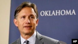 FILE - Oklahoma Attorney General Mike Hunter speaks at a news conference in Oklahoma City, April 26, 2017. Oklahoma is one of at least 13 states that have filed lawsuits against drugmakers, alleging fraudulent marketing of drugs that fueled the opioid epidemic.