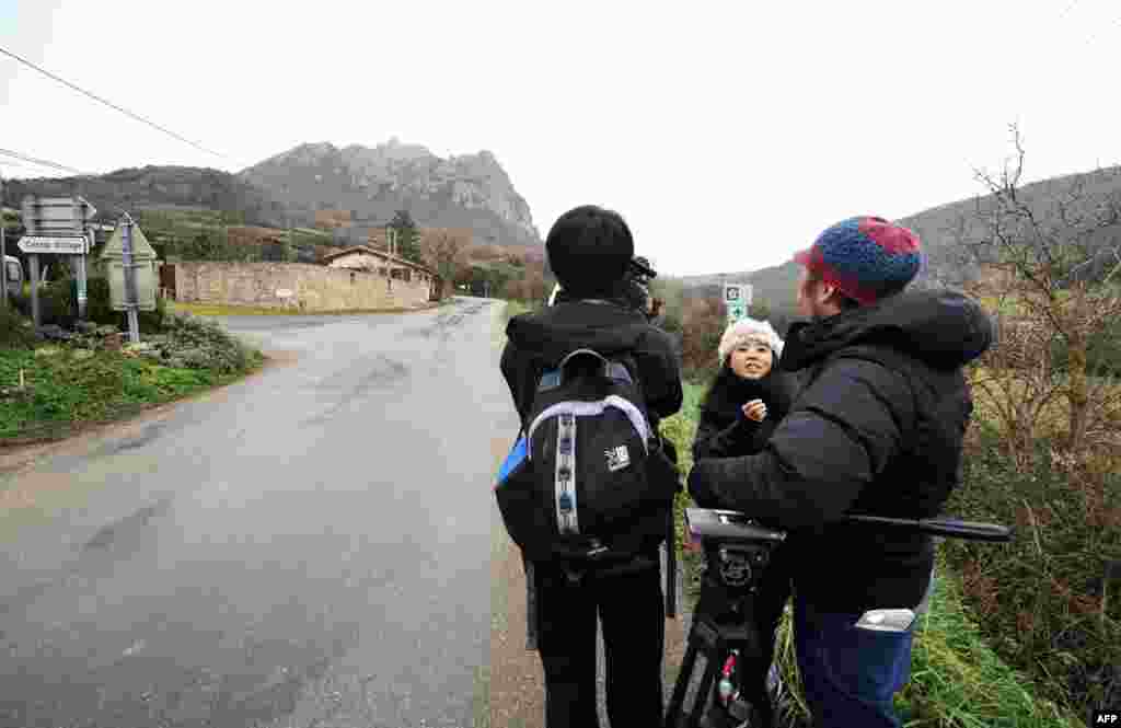 Journalists from South Korea file a report from the southwestern village of Bugarach, France on Dec. 19, 2012.