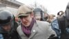 Riot police detain a protester during a rally near the state-controlled TV channel NTV tower in Moscow, March 18, 2012.