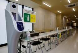 A machine to check body temperature and hand sanitizers are placed at the doping control station of the Tokyo 2020 Olympic and Paralympic Village in Tokyo, Japan, June 20, 2021.