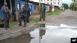 Burundian police and soldiers guard a deserted street in Bujumbura, Burundi, Sunday, Nov. 8, 2015. Rising violence in Burundi is sparking calls for greater international attention.
