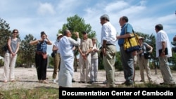 Youk Chhang, Elizabeth Becker and Michael ABRAMOWITZ, USHMM Director and his delegations at a mass grave site with a nun Sim Ry who survived the Khmer Rouge, Kampong Chhnang province. Oct 24, 2012. Photo by Nhean Socheat