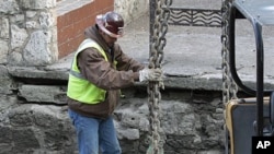A worker does his job along the San Antonio River Walk in San Antonio, Texas, after the river was drained to clean out silt and make repairs, Jan. 7, 2011