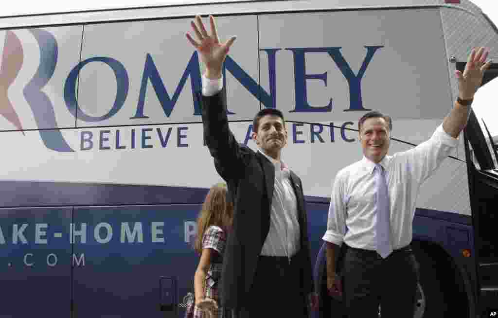 Republican presidential candidate Mitt Romney, right, and vice presidential candidate Wisconsin Rep. Paul Ryan are joined by Ryan's daughter Liza as they wave to the crowd, Aug. 11, 2012, in Norfolk, Va.