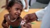 In this Oct. 1, 2018, photo, a doctor measures the arm of malnourished girl at the Aslam Health Center, Hajjah, Yemen. 