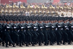 Members of a Chinese military honor guard march during the the celebration to commemorate the 70th anniversary of the founding of Communist China in Beijing, Tuesday, Oct. 1, 2019. (AP Photo/Ng Han Guan)