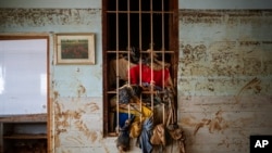 Wet clothes hangs on a window near the water level marker in an area affected by floods in Paiporta, Valencia, Spain, Nov. 5, 2024.