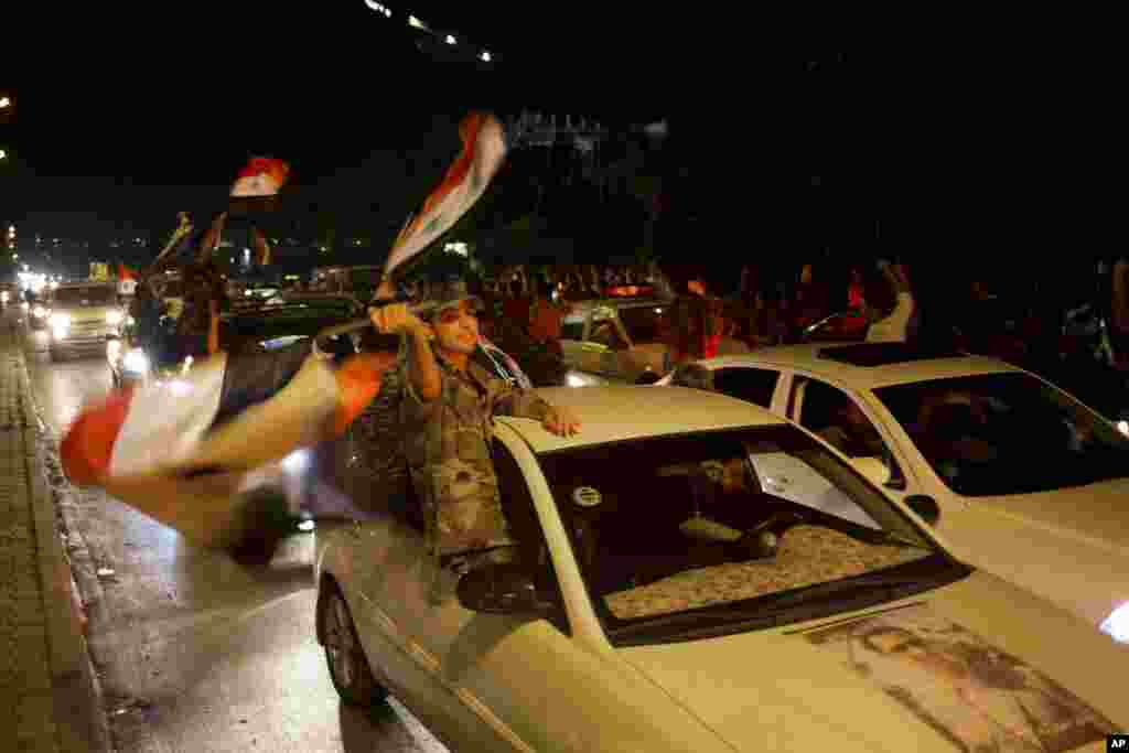 Sryian soldiers celebrate Bashar al-Assad's presidential re-election in Damascus, June 4, 2014.
