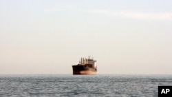 A cargo ship is seen between the Iranian city port of Bandar Abbas and Qeshm Island in the strategic waterway the Persian Gulf.