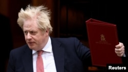 FILE - British Prime Minister Boris Johnson leaves 10 Downing Street, in London, Feb. 21, 2022.