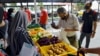 A man selects fresh produce at a mobile food bank run by Kechara in Kuala Lumpur. (Zsombor Peter/VOA)