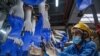 A worker inspects disposable gloves at the Top Glove factory in Shah Alam on the outskirts of Kuala Lumpur, Malaysia.