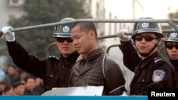 FILE - A death-sentenced criminal is taken on a truck to an execution ground in Zhuzhou, central China's Hunan province.