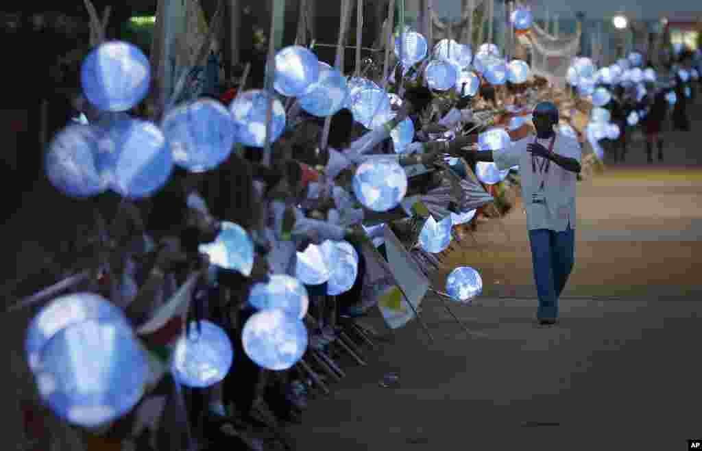 An Olympic athlete is greeted by school children lining the path to Olympic Stadium for the Opening Ceremony of the 2012 Summer Olympics, July 27, 2012, in London.