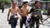 Government soldiers escort residents who were taken hostage and used as human shields by Muslim rebels of Moro National Liberation Front (MNLF) during fighting with government soldiers, in Zamboanga city in southern Philippines, Sept. 17, 2013. 