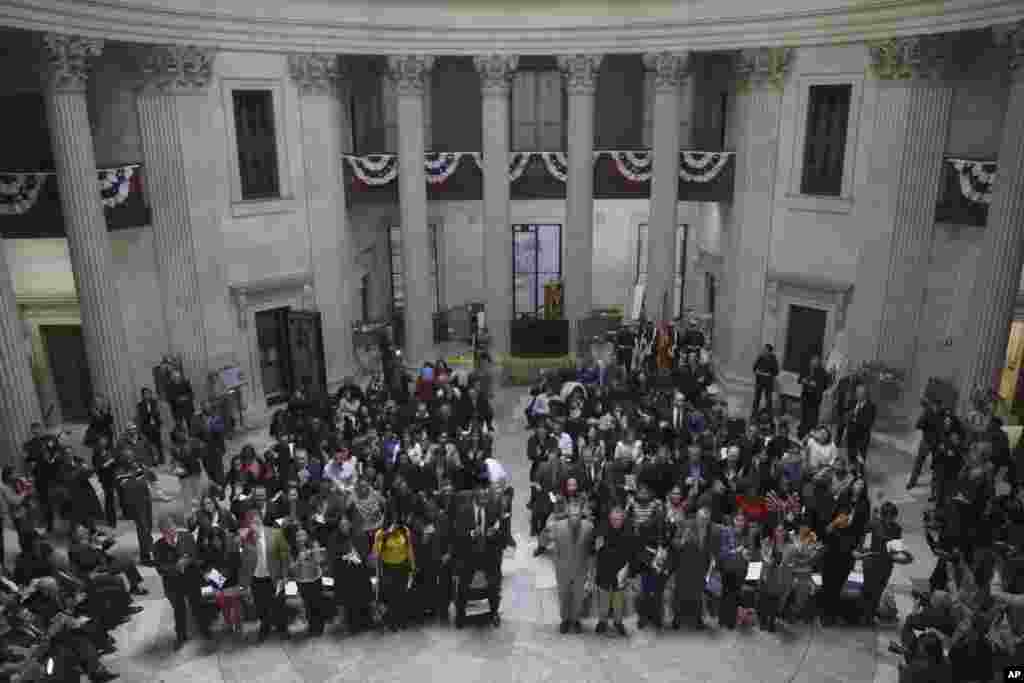 Participants take the Oath of Allegiance during a naturalization ceremony at Federal Hall in New York, March 22, 2013.