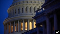 FILE - Light illuminates the U.S. Capitol dome on Capitol Hill in Washington, March 16, 2020.