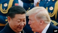 Le président américain Donald Trump, à droite, s’entretient avec le président chinois Xi Jinping à Beijing, en Chine.