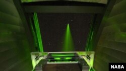 FILE - NASA’s Lunar Lasercom Optical Communications Telescope Laboratory (OCTL) Terminal, sending a laser beam to the moon.