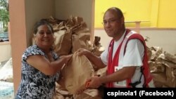 Carlos Spínola (dir) entregando cesta de comida, Porto Rico