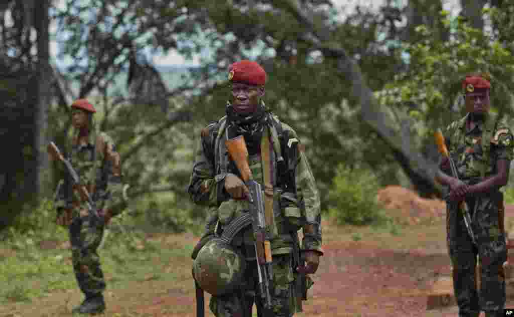Troops from the Central African Republic stand outside a building used for meetings between them and U.S. Army special forces seeking the leader of the Lord's Resistance Army, Joseph Kony, Obo, Central African Republic, April 29, 2012.