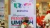 FILE - A man sits in front of banners of UMNO (United Malays National Organization) and PAS (Pan-Malaysian Islamic Party) during an event to announce an alliance between the two in Kuala Lumpur, Malaysia, Sept. 14, 2019.