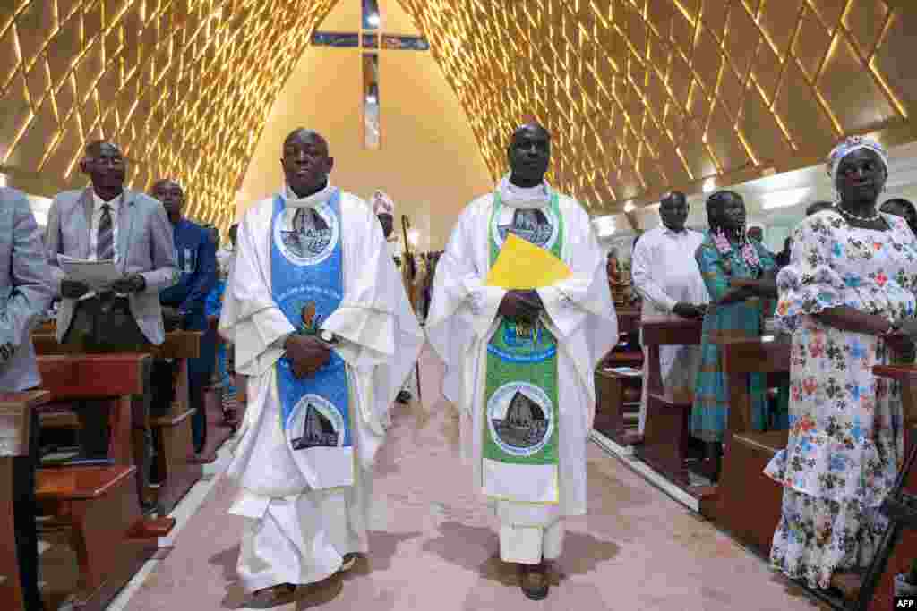Catholic priests enter the church for the Christmas mass at the Notre Dame de la Paix Cathedral in N'Djamena, Chad, Dec. 24, 2024.