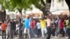 FILE - In this photo taken Oct. 26, 2015, youths supporting the opposition party dance and chant, predicting a win for their candidate, outside the Electoral Commission office in Stone Town, Zanzibar, a semi-autonomous island archipelago of Tanzania. Zanzibar is preparing for an election rerun Sunday, after polls were nullified in the region last year. 