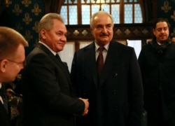 Commander of the Libyan National Army (LNA) Khalifa Haftar shakes hands with Russian Defense Minister Sergei Shoigu before talks in Moscow, Jan. 13, 2020.