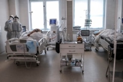 Doctors attend to a patient inside the intensive care unit for people infected with the new coronavirus, at a hospital in Moscow, Russia, May 2, 2020.