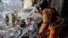 In this photo provided by the Ukrainian Emergency Service, rescuers search for the dead and injured after a Russian drone hit an apartment building in Sumy, Ukraine, Jan. 30, 2025. 