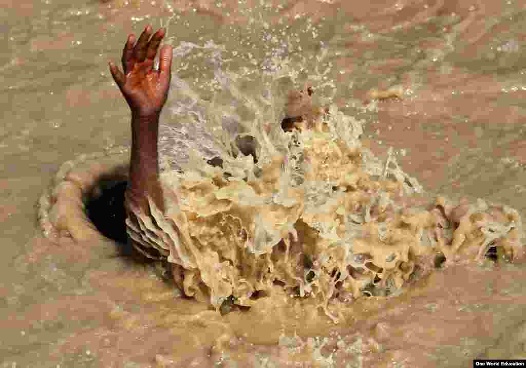 An Afghan boy swims in the muddy waters in Kabul, Afghanistan.
