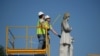 FILE - Houston city workers remove a statue of confederate soldier Dick Dowling from Hermann Park on June 17, 2020 in Houston, Texas.