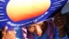 A woman holds a poster bearing the logo of the Cambodian National Rescue Party (CNRP) during a protest demanding a free and fair general election, at the Freedom Park in Phnom Penh, file photo. 