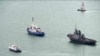 This video grab provided by the Krym 24 tv station via AP Television shows a seized Ukrainian ship, right, is towed by a Russian coast guard boat out of the port in Kerch, Crimea, Nov. 17, 2019. 