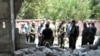 Army soldiers inspect the site of a suicide attack at a bus station in the government-held city of Hama in western Syria, in this handout picture provided by SANA on July 6, 2017, Syria.