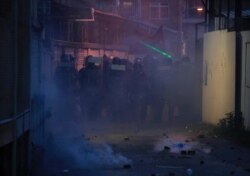 Riot police block a road into Yuen Long district in Hong Kong, July 27, 2019. Hong Kong police on Saturday fired tear gas and swung batons at protesters who defied warnings not to march in a neighborhood where earlier a mob brutally attacked people.